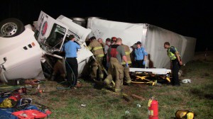 Emergency crews work to remove a truck driver from his overturned tractor-trailer in Athens Monday night. (Photo: J. Brierton / Grady NewSource)