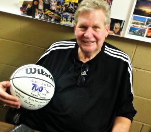 Coach Ron Link of the Athens Christian Eaglesholding clingged to this basketball signed by his players commemorating his 700 career wins as a coach. 