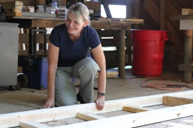 Kim Skobba, a professor at UGA, works on a ladder for the tiny home that she and her students are building together.
