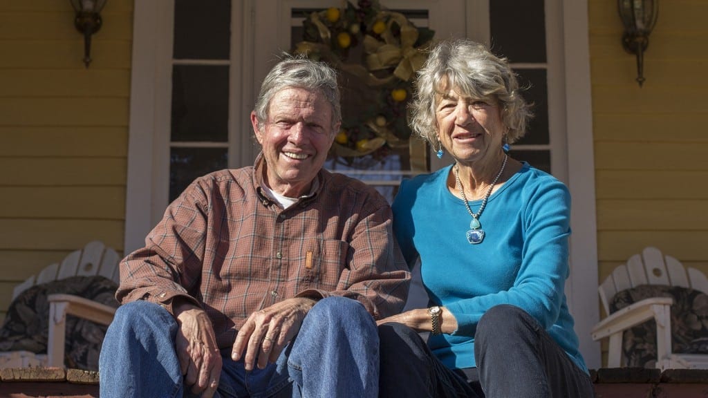 Bill Birkhead, a 74-year-old retired professor from Providence, Rhode Island, and his wife of over 50 years Faith Birkhead, a 73-year-old retired artist from Long Island, New York, pose for a portrait on their property in Hamilton, Georgia. The two have lived there together for more than 30 years. (Photo/Jenny Goldberger, www.jennygoldberger.com)