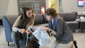 Teena Wilhelm learns about new medication her dog, Enzo, will be taking.