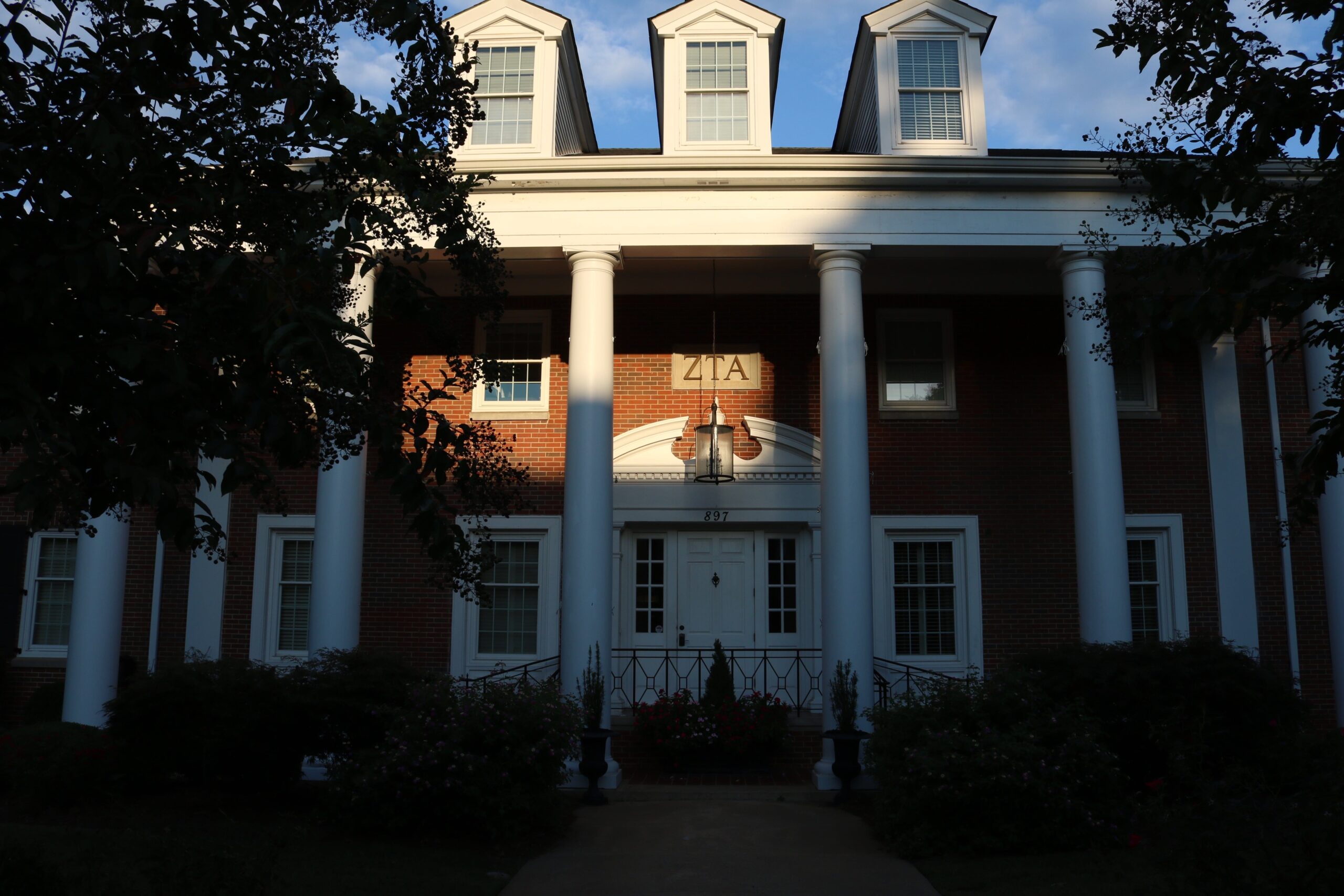 The sun sets over the Zeta Tau Alpha house, located at 897 S. Milledge Ave. in Athens, Georgia. The house is owned by Zeta Tau Alpha Fraternity Housing. It is currently valued at $1.8 million. (Photo by Emma Fordham)