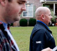 Justin Strength looks to see where the next house is while walking alongside Marcus Wiedower on Friday, November 2, 2018 in Watkinsville, Georgia. Wiedower is the Republican candidate running for State House in Georgia House district 119. (Emily Graven, emilyrgraven@gmail.com)