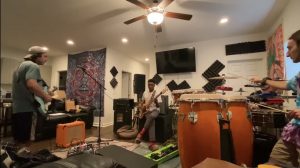 Members of the band Undeground Springhouse rehearse prior to the pandemic.