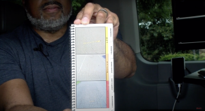 McGhee holding out a paper showing different types of alligator cracks.