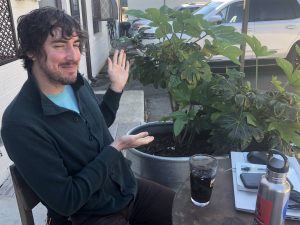 ACC Commissioner Houle poses in front of a potted plant.