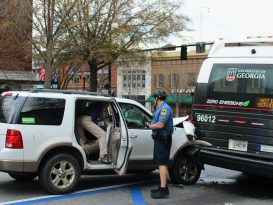 Officer Seth Jones arrives at the scene of a collision between a vehicle and a UGA bus on February 16, 2022 in Athens, GA. (Photo/Eloise Cappelletti)