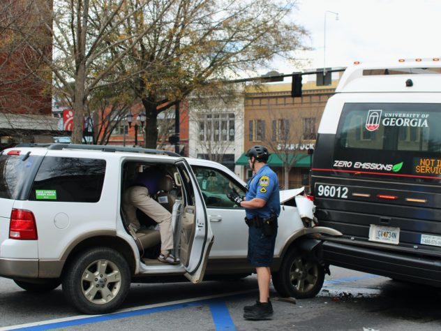 Officer Seth Jones arrives at the scene of a collision between a vehicle and a UGA bus on February 16, 2022 in Athens, GA. (Photo/Eloise Cappelletti)