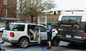 Officer Seth Jones arrives at the scene of a collision between a vehicle and a UGA bus on February 16, 2022 in Athens, GA. (Photo/Eloise Cappelletti)
