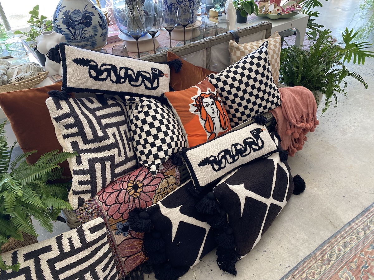 Throw pillows of different shapes, sizes and colors on display at Jade Joyner's shop.