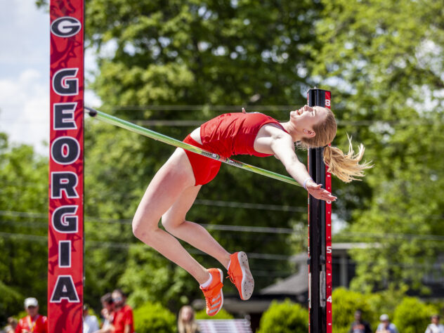 A University of Georgia high jumper sails over the bar at a meet in Athens.