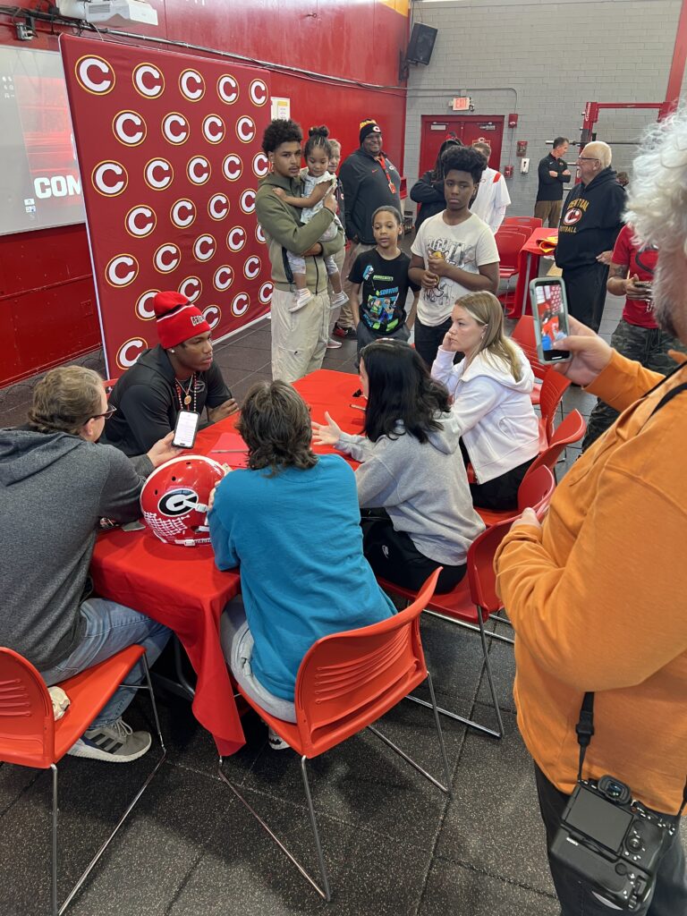 Clarke Central football player Hezekiah Millender talks to the media after committing to attend the University of Georgia on a football scholarship. Courtesy Clarke Central High School