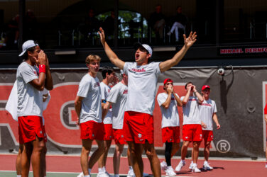 A tennis player celebrates at a match.