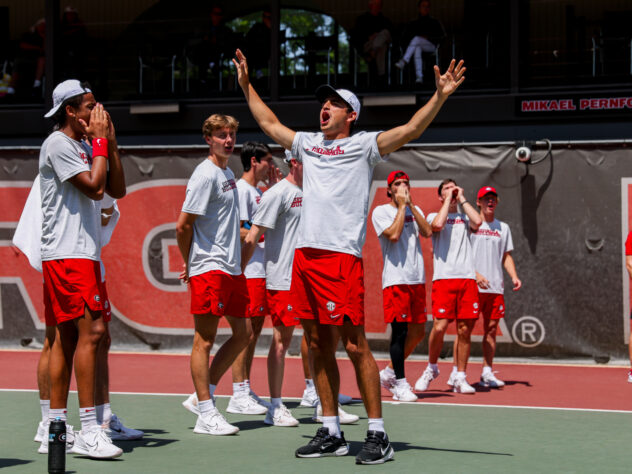 A tennis player celebrates at a match.