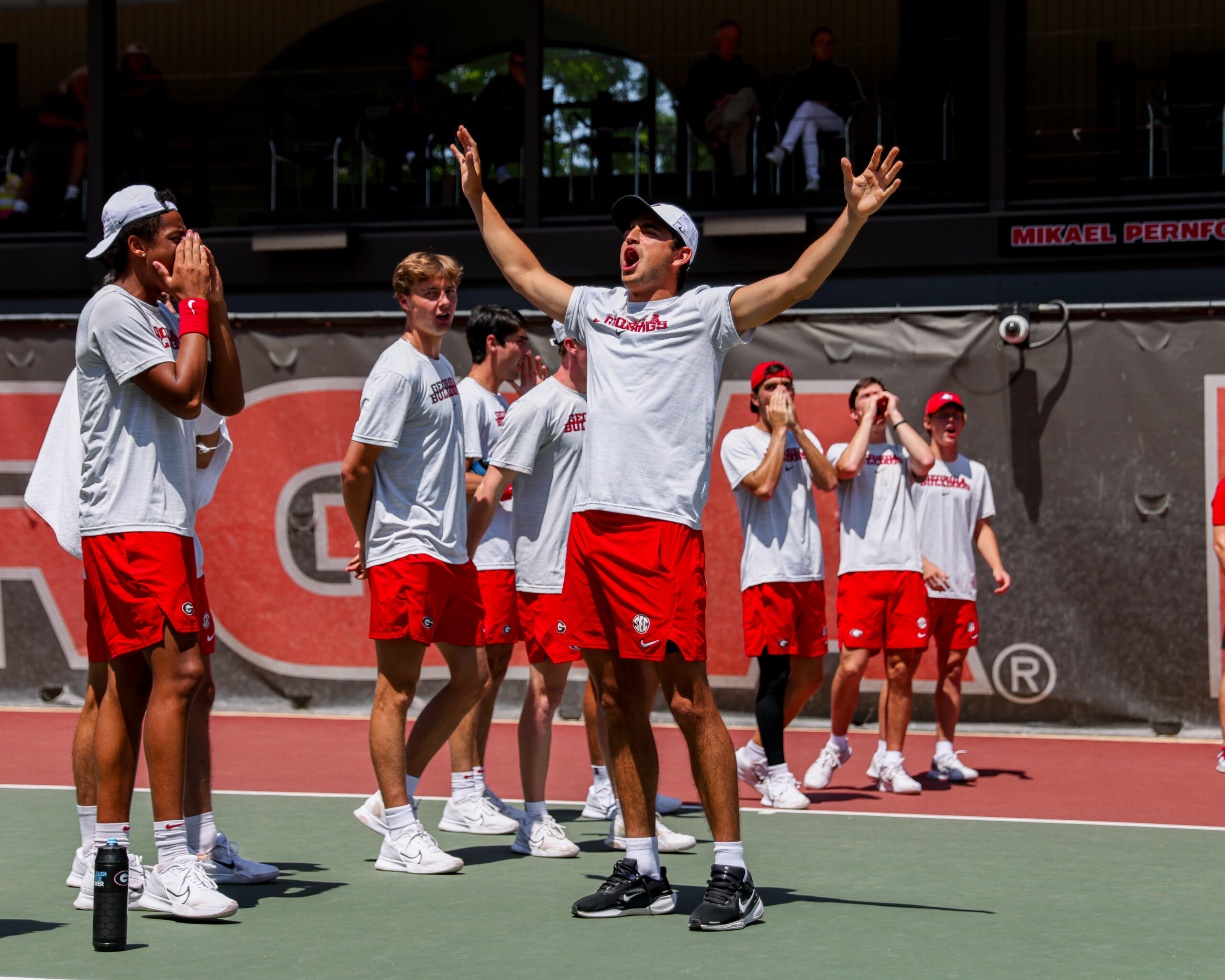 A tennis player celebrates at a match.