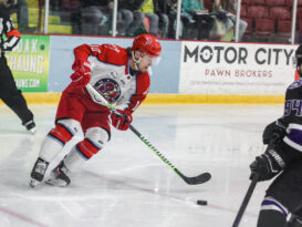 A hockey player controls the puck