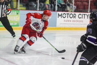 A hockey player controls the puck