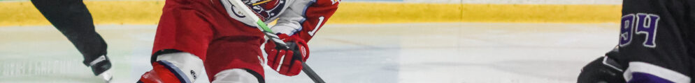 A hockey player controls the puck