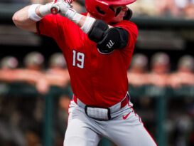 A baseball batter prepares to take a pitch.