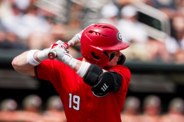 A baseball batter prepares to take a pitch.