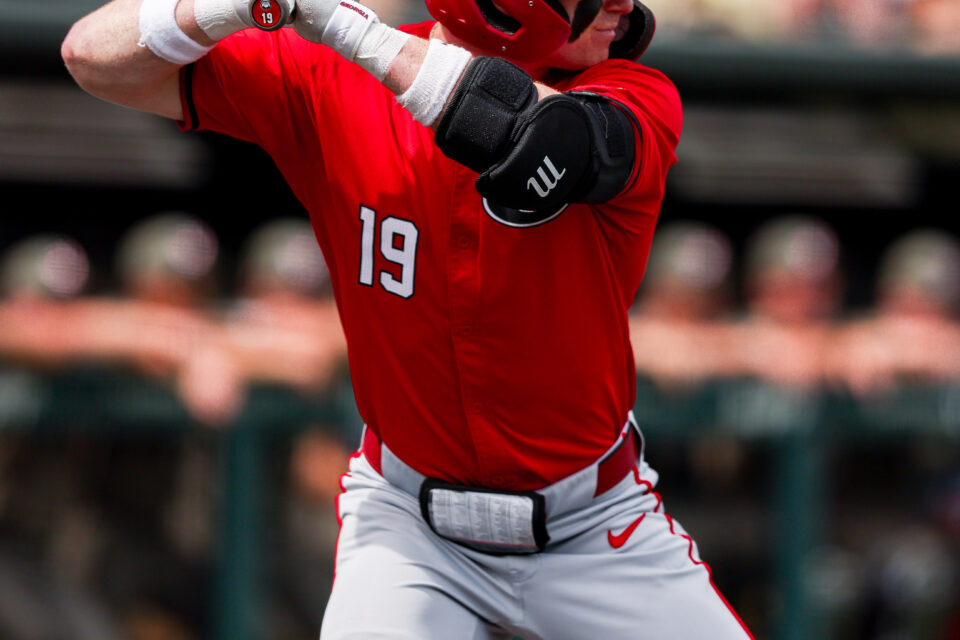 A baseball batter prepares to take a pitch.