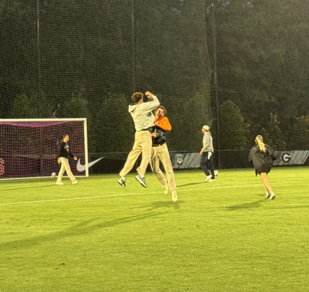 Two fans jump into the air