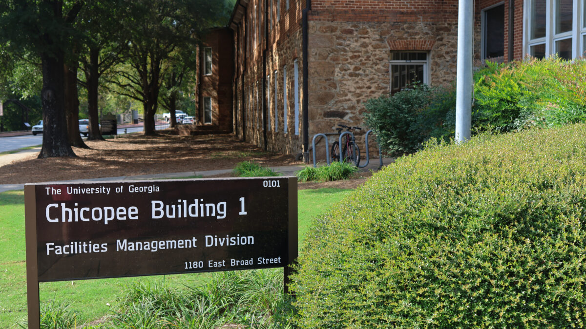 A sign in front of a building on the campus of the University of Georgia for the office of sustainability