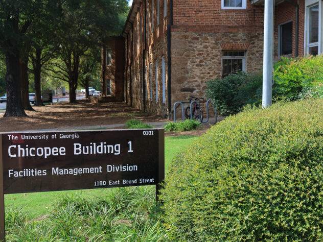 A sign in front of a building on the campus of the University of Georgia for the office of sustainability