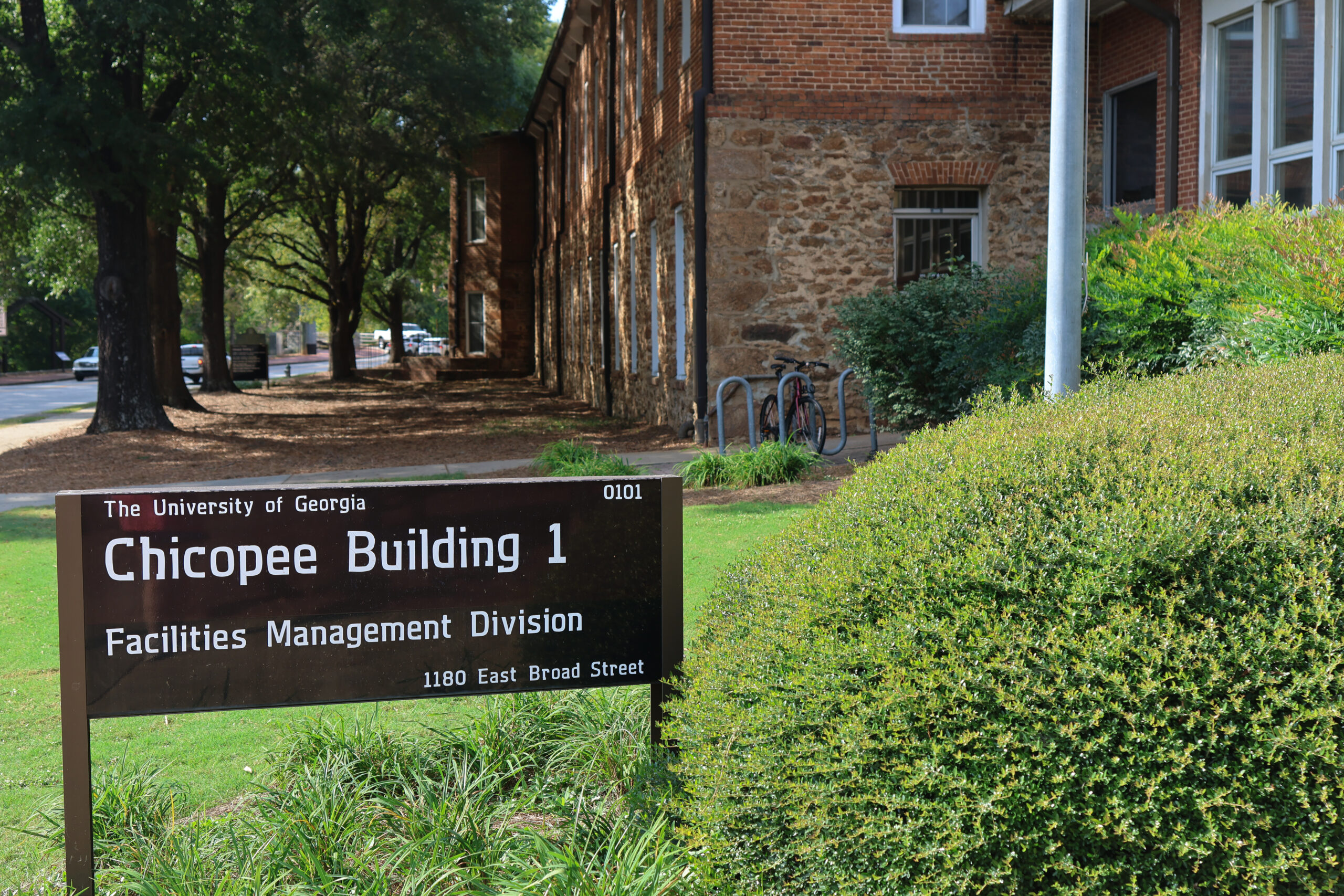 A sign in front of a building on the campus of the University of Georgia for the office of sustainability