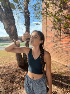 A high school runner kisses a rubber fishing worm for good luck.