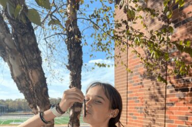 A high school runner kisses a rubber fishing worm for good luck.
