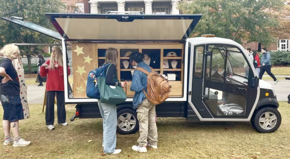 Two people ordering food from a merchandise truck