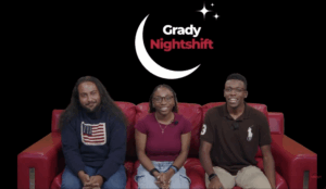 Three hosts sitting on a red couch with the Grady Nightshift logo behind them