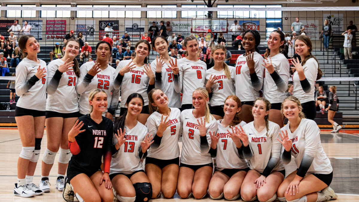 A volleyball team celebrates a title