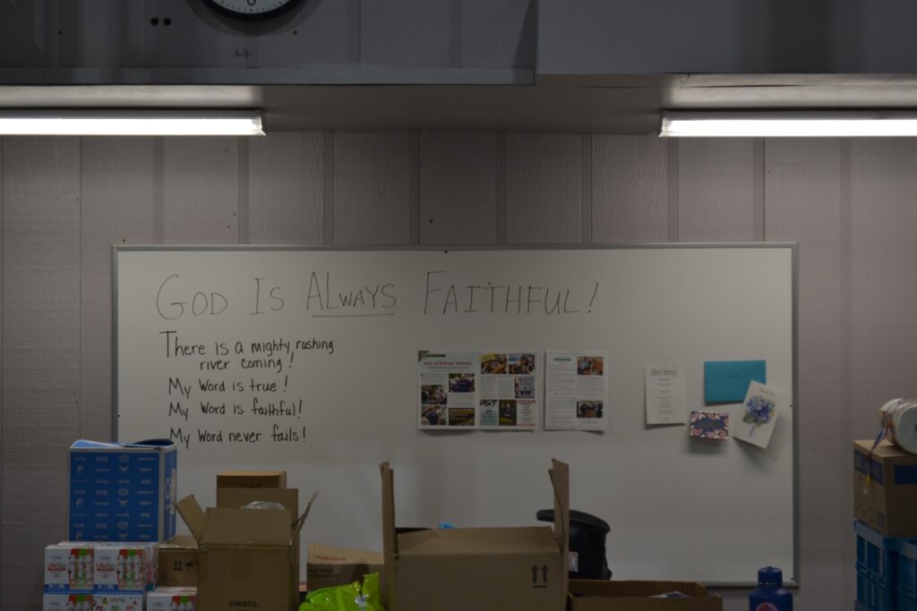 A sign in a warehouse reads "God is always faithful!"