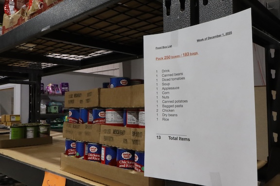 Boxes of food on a shelf next to a list of items