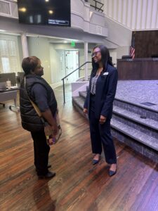 Two women stand talking in a room