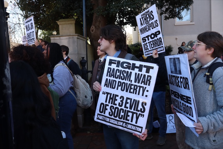 Students hold signs protesting President Trump and ICE