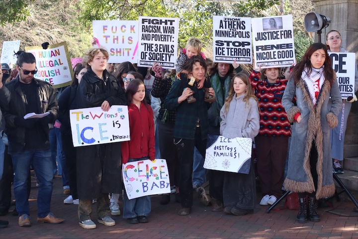 A group of people holds signs.
