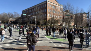 A large amount of students use crosswalks during a passing time in the class schedule.