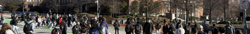 A large amount of students use crosswalks during a passing time in the class schedule.