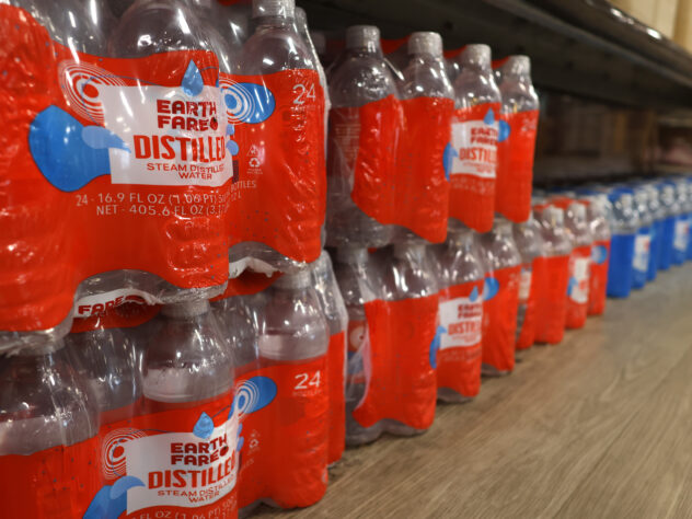 Bottled water is on a shelf in a store