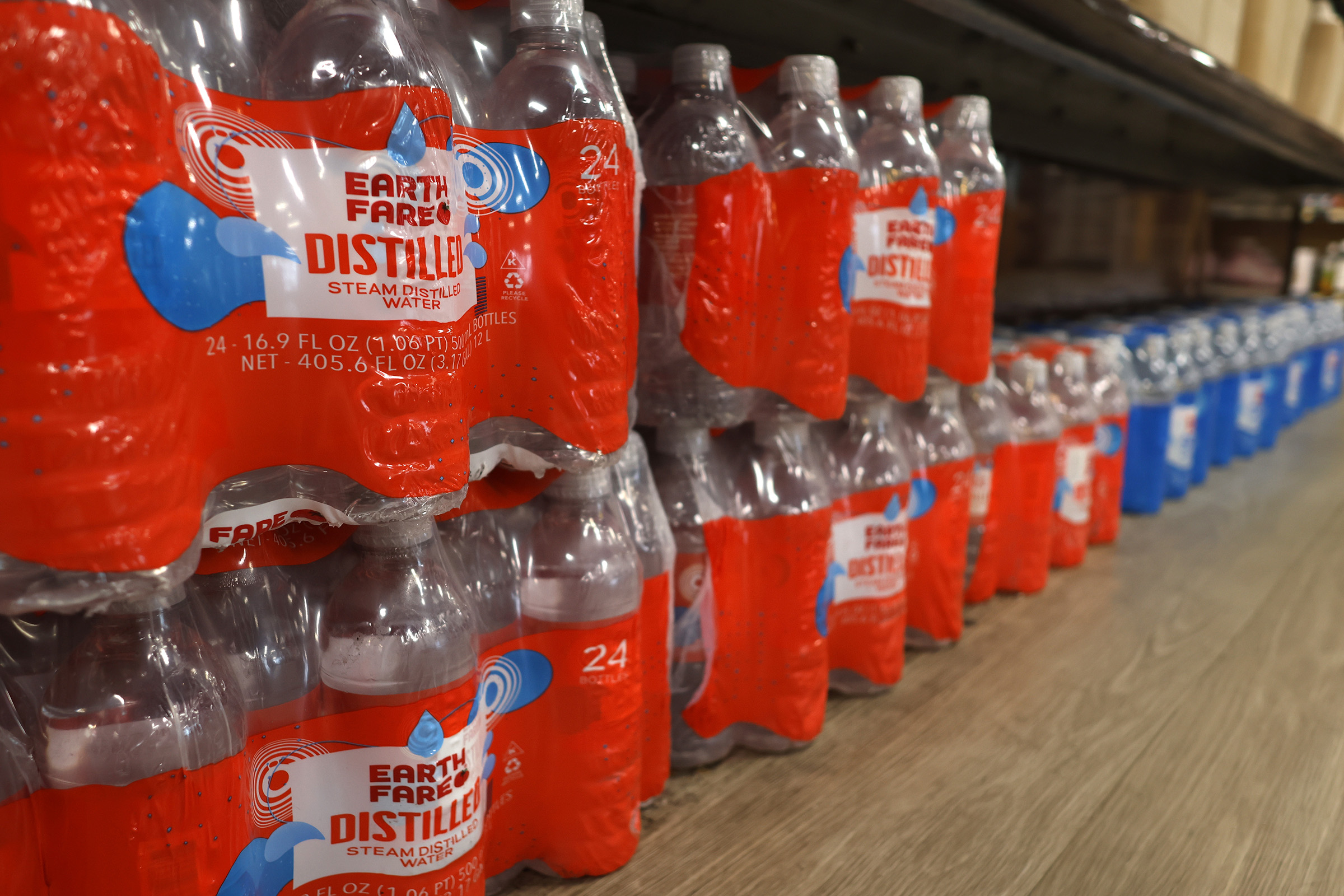 Bottled water is on a shelf in a store
