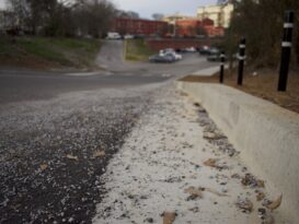 Gravel and other debris lines the curb near University of Georgia Police Department parking lot on Feb. 27, 2026