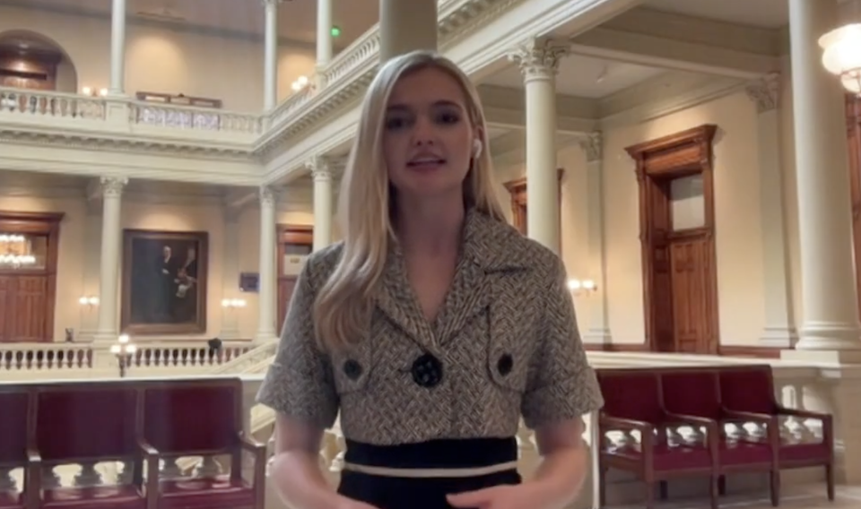 A reporter stands in the rotunda at the Georgia statehouse