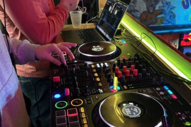 A turntable with two people standing nearby