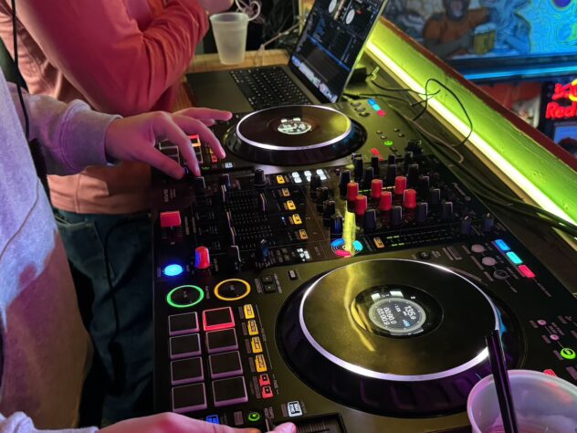 A turntable with two people standing nearby