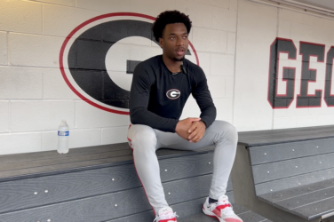 UGA baseball player sits in the dugout to be interviewed