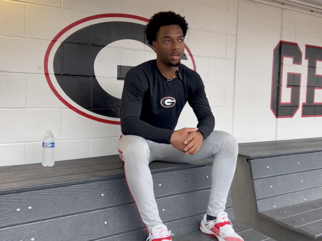 UGA baseball player sits in the dugout to be interviewed