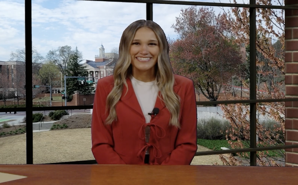 Woman sits at anchor desk